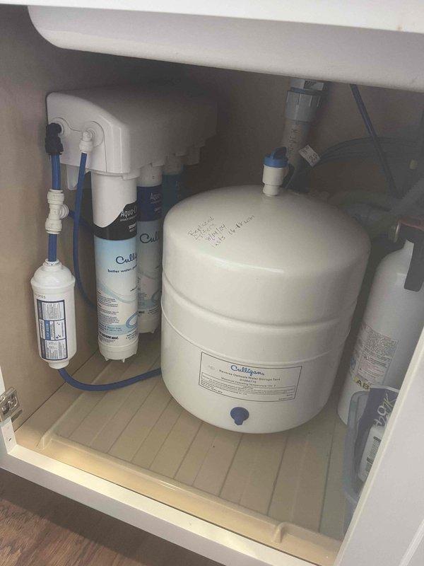 Diagnosed and repaired condensation pump issue on Rinnai tankless water heater system. Verified proper operation of connected water filtration system including Culligan storage tank and filter assembly. System now functioning at correct temperature (130°) with no leaks observed.
