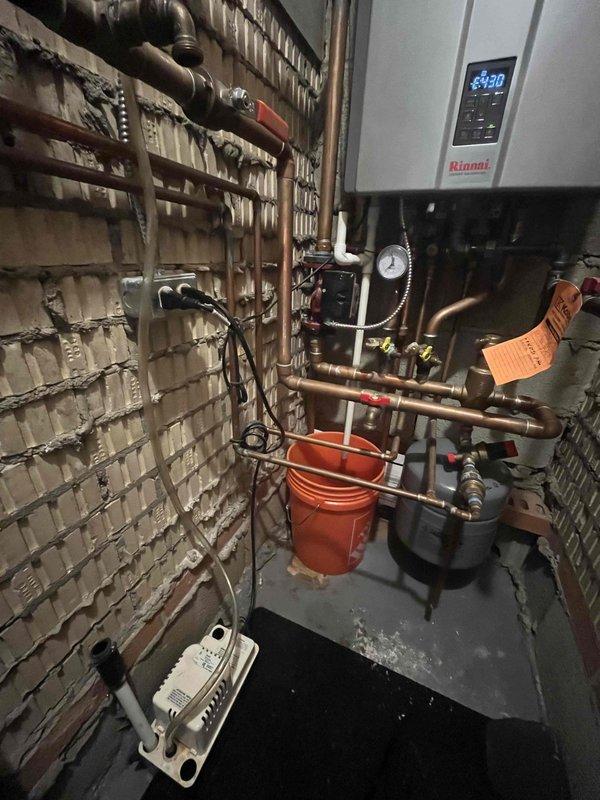 Diagnosed and repaired condensation pump issue on Rinnai tankless water heater system. Verified proper operation of connected water filtration system including Culligan storage tank and filter assembly. System now functioning at correct temperature (130°) with no leaks observed.