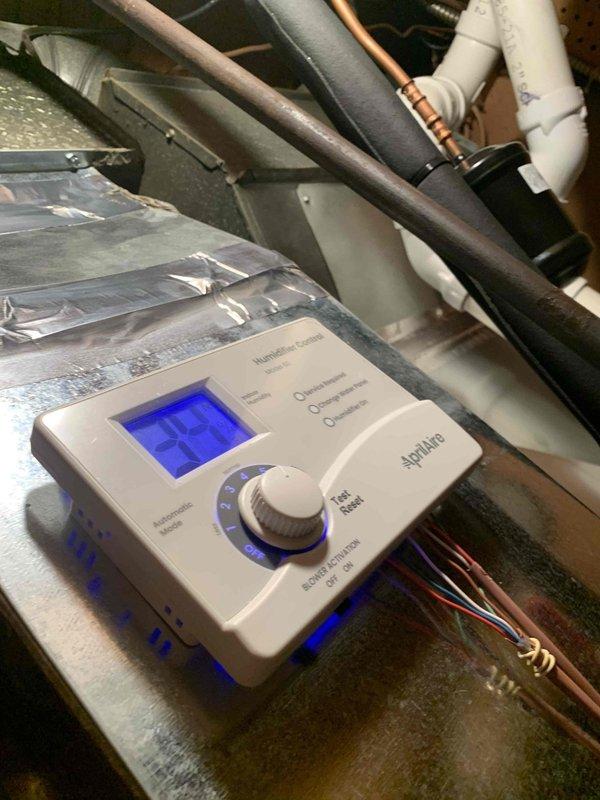 Performed heating maintenance on member's air handler system. Checked AprilAire control unit displaying "35" and verified proper operation of system components. Used SC480 digital multimeter to test electrical readings, confirming normal amperage draw of 0.33A across HVAC components.