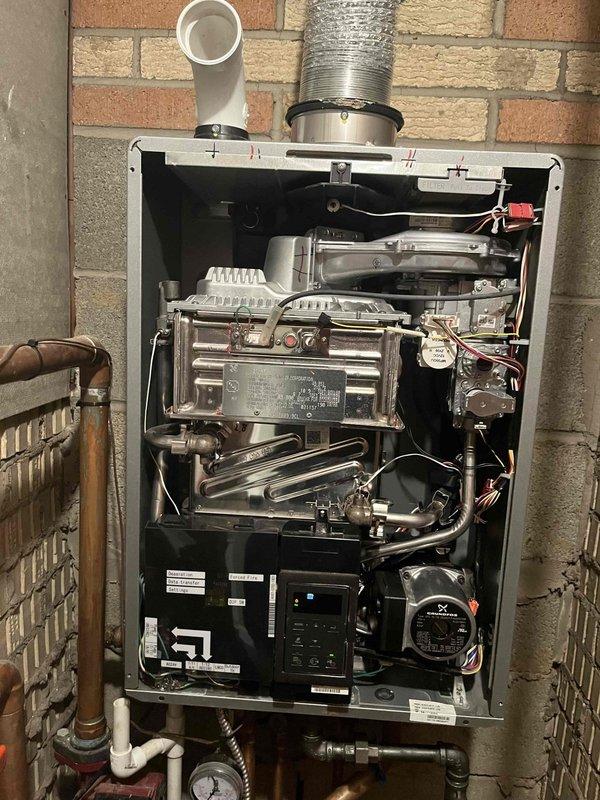 Responded to service call for combi boiler displaying error code E430.AZ. Performed diagnostic inspection of internal components including heat exchanger, control panel, and valve assembly. Cleared error code and verified proper system operation with normal pressure readings on gauge.