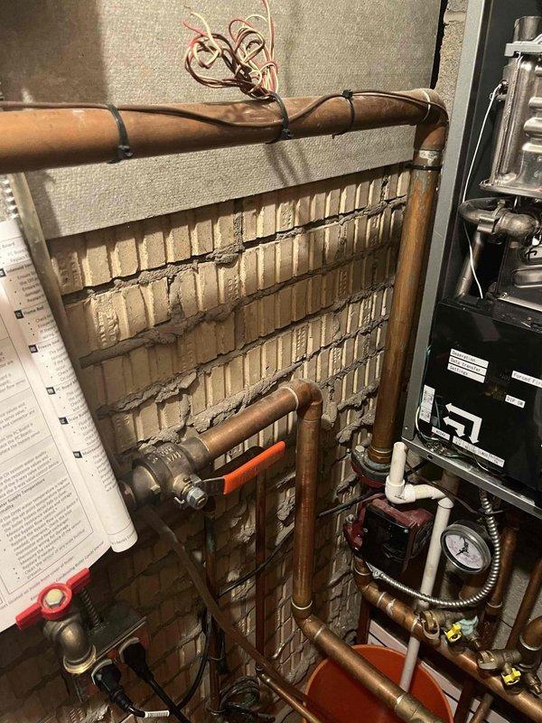 Responded to service call for combi boiler displaying error code E430.AZ. Performed diagnostic inspection of internal components including heat exchanger, control panel, and valve assembly. Cleared error code and verified proper system operation with normal pressure readings on gauge.