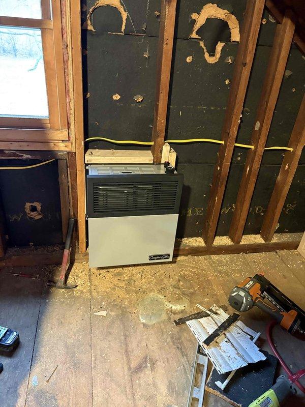 Performed site assessment for gas line installation in an unfinished interior space with exposed framing and joists. Evaluated existing wall-mounted heating unit connections and documented current infrastructure including HVAC components. Provided quote for complete gas piping service to properly supply the heating system while ensuring code compliance during ongoing construction/renovation.