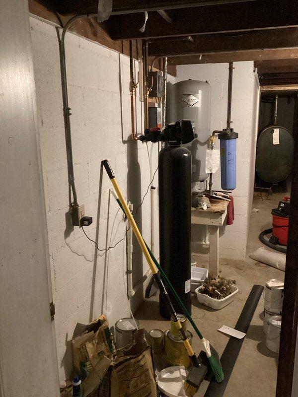 Conducted on-site assessment of water quality issues after customer reported white staining when boiling water. Inspected existing Katalox filtration system and current water treatment setup, including the primary filter tank and auxiliary components. Provided customer with a quote for water softener installation as recommended solution to address mineral deposits causing the staining problem.