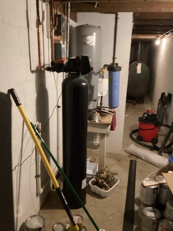 Conducted on-site assessment of water quality issues after customer reported white staining when boiling water. Inspected existing Katalox filtration system and current water treatment setup, including the primary filter tank and auxiliary components. Provided customer with a quote for water softener installation as recommended solution to address mineral deposits causing the staining problem.