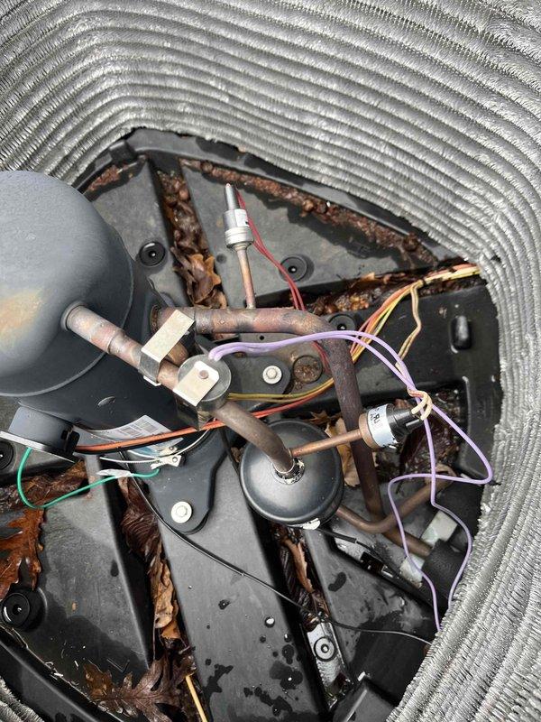 Returned to complete sold repair work, installing the air scrubber UV bulb as planned. Inspected outdoor unit and documented debris accumulation inside housing that requires cleaning. Crank case heater installation pending due to parts availability; will schedule follow-up once component arrives.
