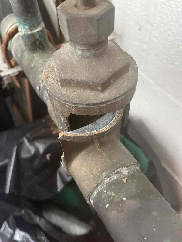 Replaced leaking valve on wall-mounted urinal in commercial restroom. Removed corroded copper pipe fittings with mineral deposits and installed new valve assembly. Verified proper operation and confirmed no leaks after installation.