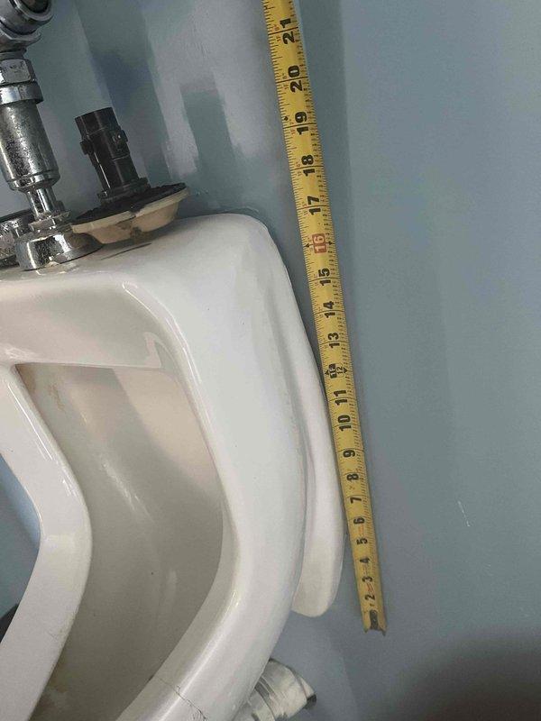 Replaced leaking valve on wall-mounted urinal in commercial restroom. Removed corroded copper pipe fittings with mineral deposits and installed new valve assembly. Verified proper operation and confirmed no leaks after installation.