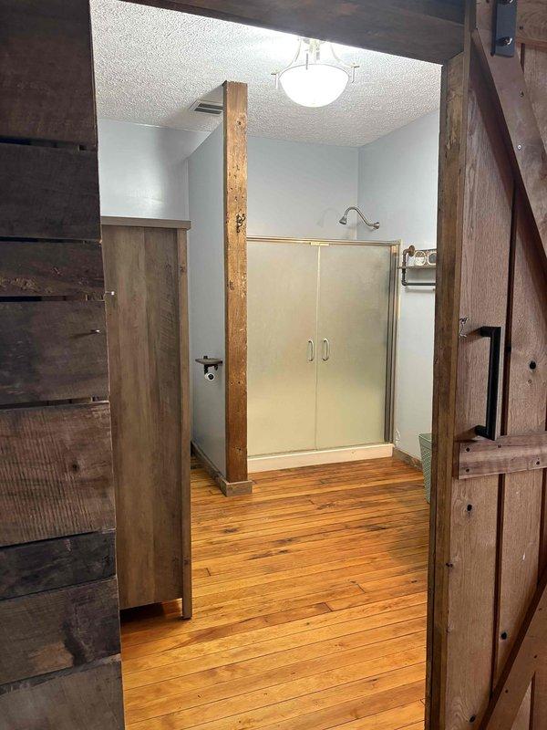 Conducted on-site assessment for installation of replacement boiler in laundry room to service existing cast iron radiator heating system. Documented current installation including vintage cast iron radiators, existing plumbing connections, and surrounding room configurations to determine appropriate specifications for new boiler unit.