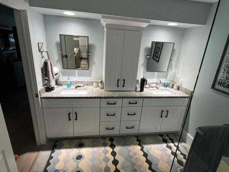 Returned to property to complete previously sold repair of jet garage floor drain. Documented existing bathroom vanity configuration and inspected expansion tank installation with connected copper supply lines. Confirmed proper operation of the floor drain system after service completion.