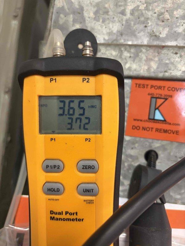 Conducted heating maintenance for club member. Performed gas pressure testing using dual port manometer, confirming readings of 3.65 and 3.72 inWG at test ports. Inspected ductwork system throughout ceiling area, verifying proper installation and integrity of all connections.