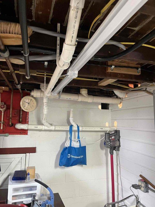 Responded to service call for a clogged toilet with backup issues and kitchen sink gurgling. Performed inspection of the plumbing system, including examination of basement utility room infrastructure to identify potential blockage points. Utilized electronic detection equipment outdoors to locate and access cleanout, then cleared the main drain line obstruction to restore proper drainage function to both affected fixtures.