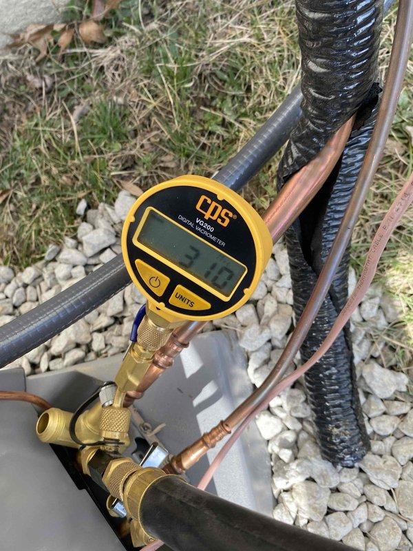 Completed installation of approved A/C system with proper pressure testing (manometer reading 3.7). Installed and verified electrical disconnect box with TR20R fuses on exterior wall, ensuring level mounting on vinyl siding. All copper line connections properly secured and insulated with system pressure-tested for optimal operation.