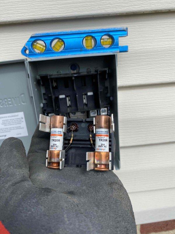 Completed installation of approved A/C system with proper pressure testing (manometer reading 3.7). Installed and verified electrical disconnect box with TR20R fuses on exterior wall, ensuring level mounting on vinyl siding. All copper line connections properly secured and insulated with system pressure-tested for optimal operation.