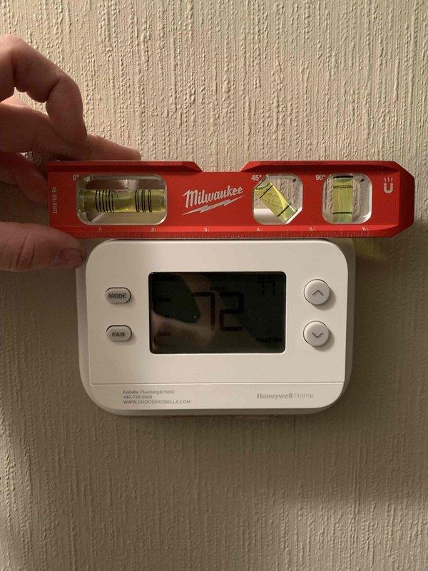 Performed service call for non-functioning thermostat. Inspected Honeywell digital thermostat displaying 72°F and verified proper level using Milwaukee level tool. Examined Amana furnace unit and associated ductwork, confirming electrical connections and condensate removal system were operational. Thermostat functionality was successfully restored.