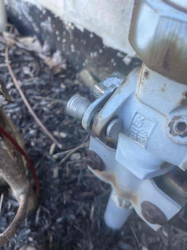 Responded to active gas leak notification (65w AH) previously identified by gas company. Inspected exterior gas valve connection showing signs of weathering and corrosion at foundation area. Examined interior gas line infrastructure including black PVC pipe installation with 90-degree bend running along wooden joists near electrical junction box. Performed pressure test to locate and repair leak, ensuring system integrity and safety compliance.