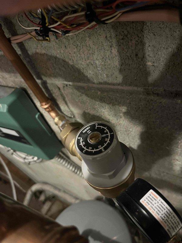 Responded to callback for recently installed Navien unit with no domestic hot water. Inspected system and identified plumbing issue rather than HVAC problem. Checked temperature gauge (reading approximately 90°F) and pressure regulator. Recommended senior plumbing technician to resolve the water supply issue affecting the unit's DHW functionality.