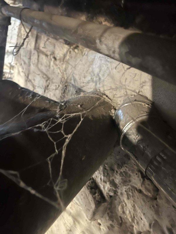 Conducted assessment of aging boiler system showing significant corrosion and deterioration. Measured pipe connections and examined junction points in utility area, noting multiple issues including rust damage and poor insulation. Customer is considering replacement with a combi system after property experienced freezing damage over winter; awaiting follow-up to discuss replacement options.