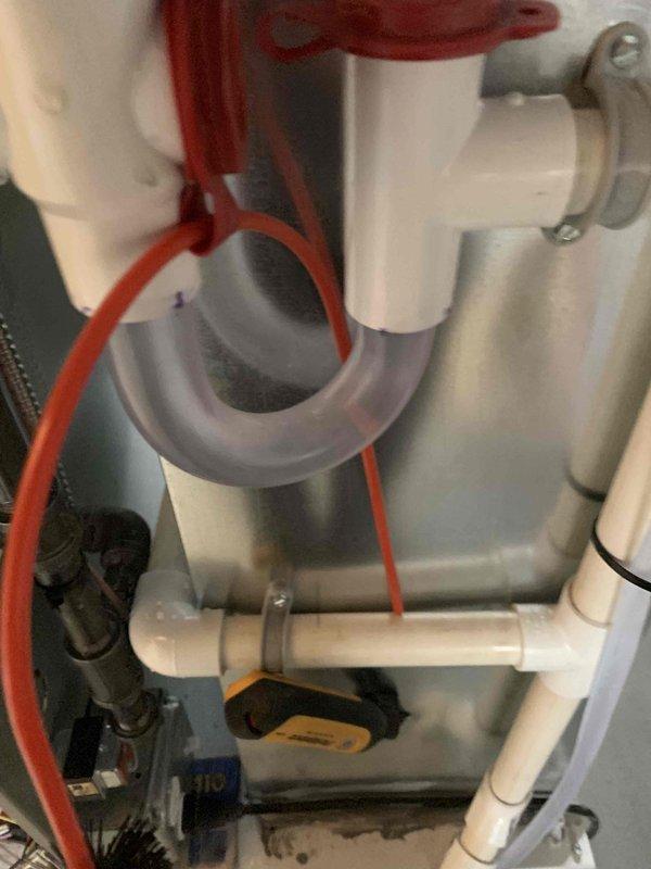 Performed scheduled start-up maintenance service. Inspected plumbing components including PVC drain system with P-trap and control valves, confirming proper installation with no leaks. Verified thermostat operation (American Standard model) with system in cooling mode at 68°F setpoint, confirmed proper programming and functionality with system idle at time of inspection.