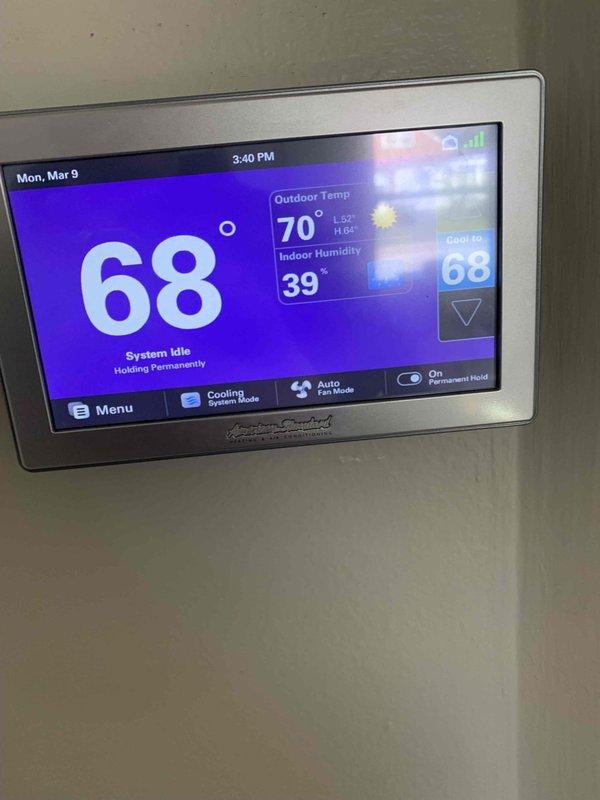 Performed scheduled start-up maintenance service. Inspected plumbing components including PVC drain system with P-trap and control valves, confirming proper installation with no leaks. Verified thermostat operation (American Standard model) with system in cooling mode at 68°F setpoint, confirmed proper programming and functionality with system idle at time of inspection.