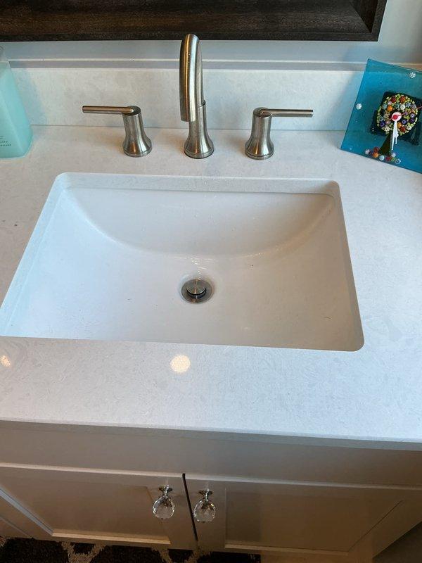 Performed membership service visit to assess poor water flow issue at basement bathroom sink. Inspected faucet connections and determined need for replacement of supply lines due to flow restriction. Recommended replacement of existing brushed nickel faucet assembly to resolve persistent low water pressure problem.