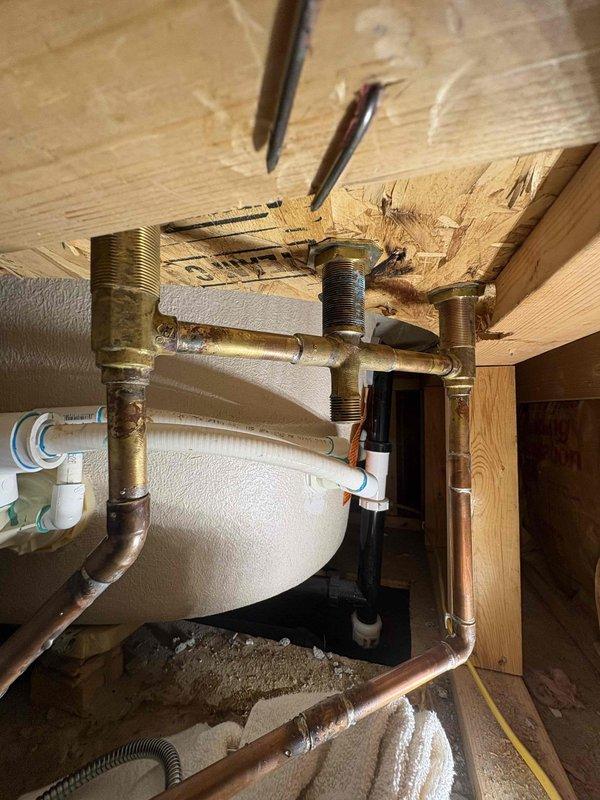Successfully replaced customer-supplied Roman tub valve body under warranty originally sold by Homer. Accessed valve through confined wooden structural space, disconnected existing brass/copper plumbing components, and installed new valve assembly. Verified proper connection of all PVC, copper, and brass plumbing components with no leaks after installation.