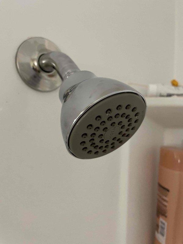 Successfully installed new shower valve and trim kit as previously sold. Completed copper pipe connections to the valve with proper fittings inside the access panel, and mounted matching chrome shower head with proper sealing. System tested with no leaks observed.