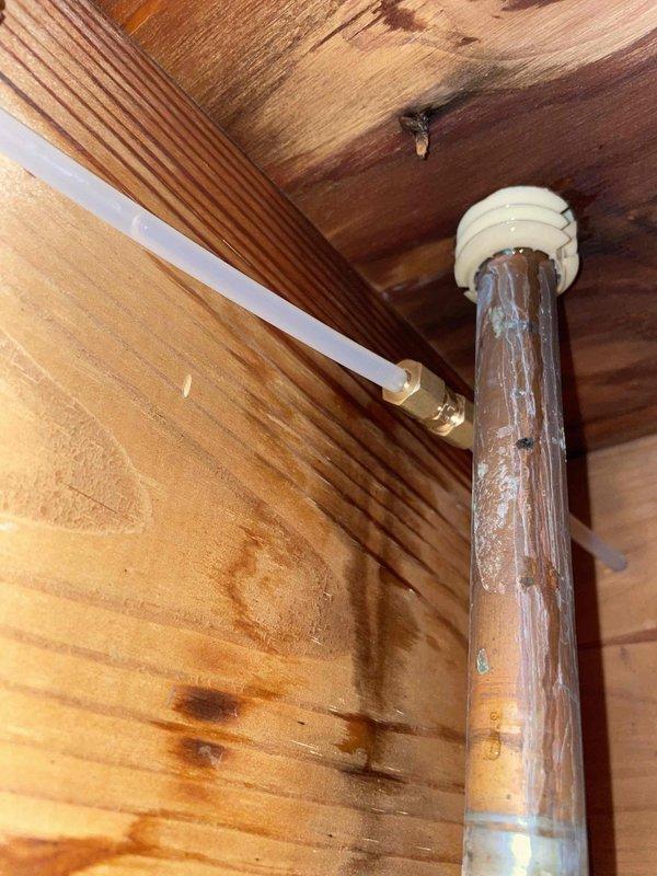 Identified and repaired a leak in the 4-loop hydronic boiler system, specifically at a copper pipe junction with visible corrosion and water damage to surrounding wooden structures. Inspected all associated plumbing components including the manual shutoff valve and horizontal copper supply lines to ensure proper system operation after repair.