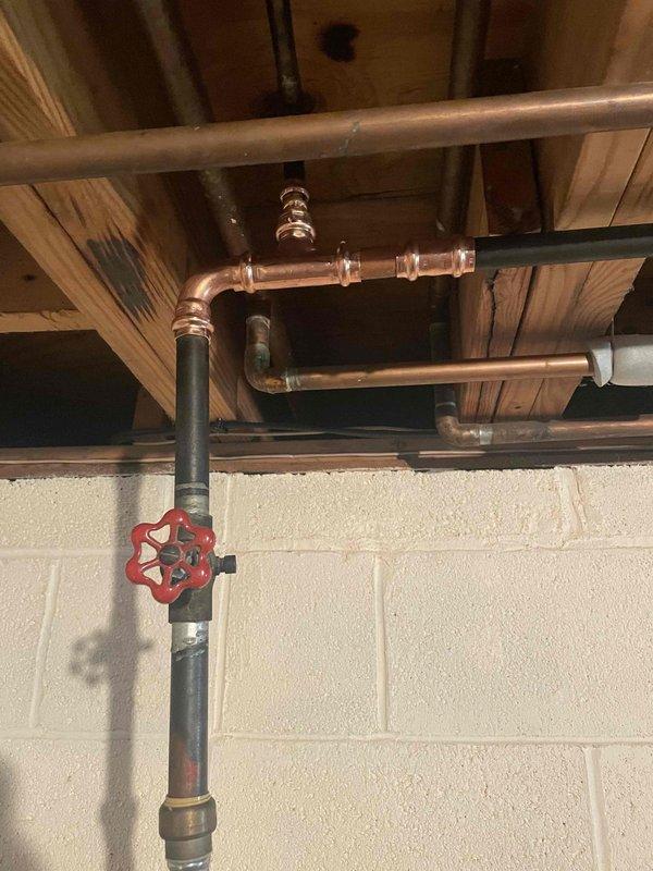 Identified and repaired a leak in the 4-loop hydronic boiler system, specifically at a copper pipe junction with visible corrosion and water damage to surrounding wooden structures. Inspected all associated plumbing components including the manual shutoff valve and horizontal copper supply lines to ensure proper system operation after repair.