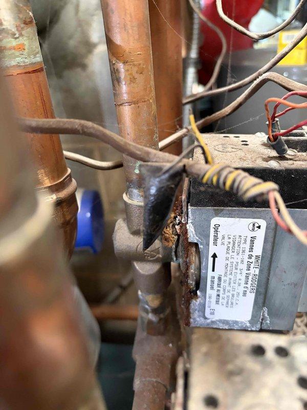 Inspected boiler with pilot light ignition failure occurring for over one year and identified White-Rodgers automatic valve leaking. Documented significant oxidation and corrosion on copper pipes connecting to control assembly, with incomplete ignition sequence preventing proper system operation.