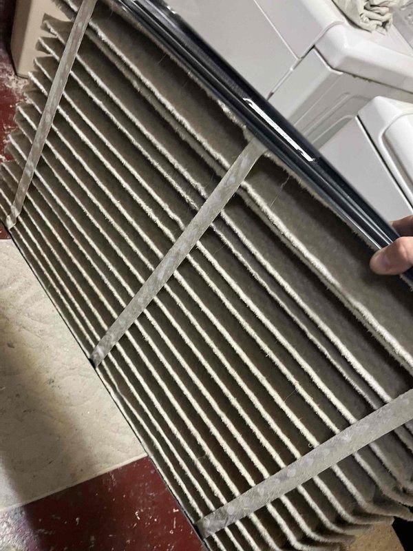 Responded to no-cooling call for system less than 10 years old. Discovered severely clogged filter with substantial dust accumulation impeding proper airflow. Replaced dirty filter and cleaned filter housing to restore proper system operation and cooling performance.