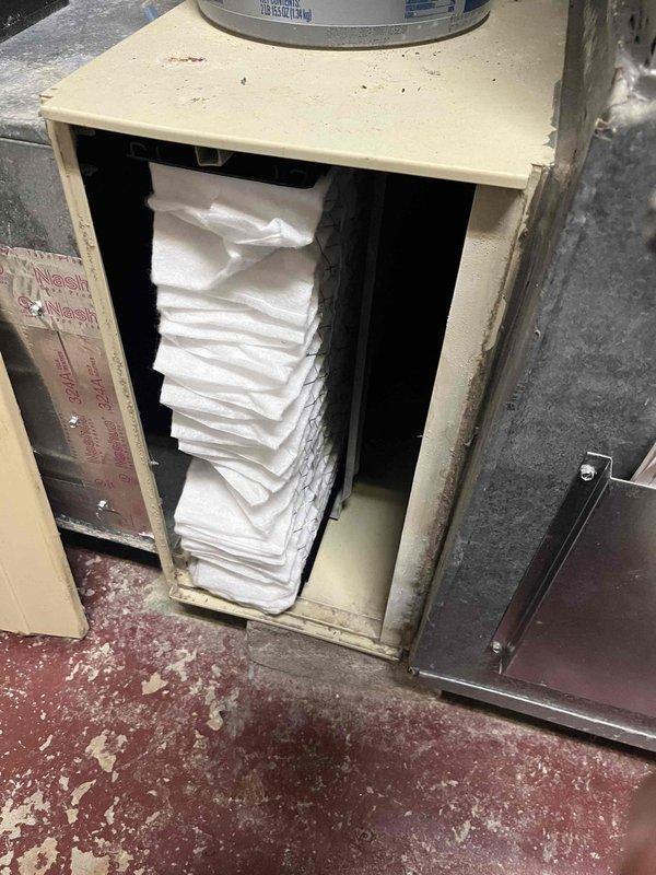 Responded to no-cooling call for system less than 10 years old. Discovered severely clogged filter with substantial dust accumulation impeding proper airflow. Replaced dirty filter and cleaned filter housing to restore proper system operation and cooling performance.