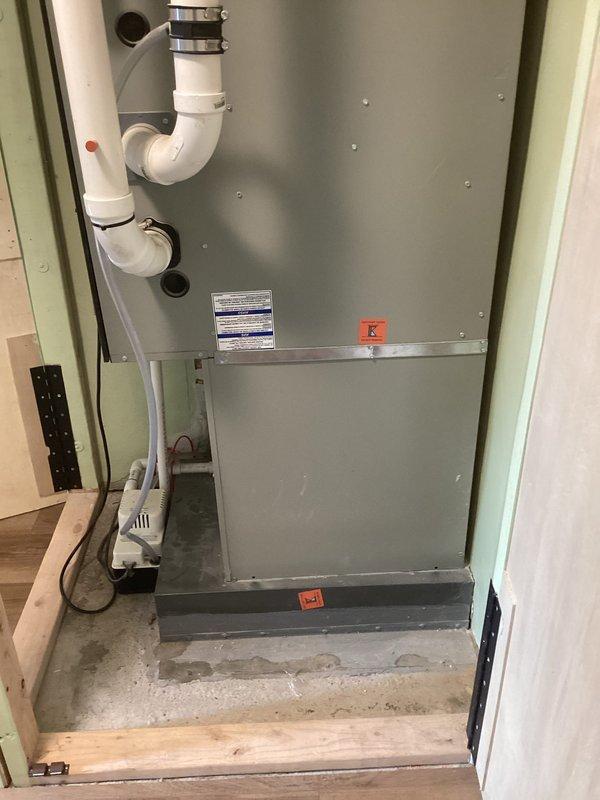 Conducted site evaluation of existing Kobella HVAC system for potential AC or mini-split replacement options. Unit is installed in wall enclosure with PVC drainage pipes and condensate pump. Previously replaced furnace remains in good working condition.