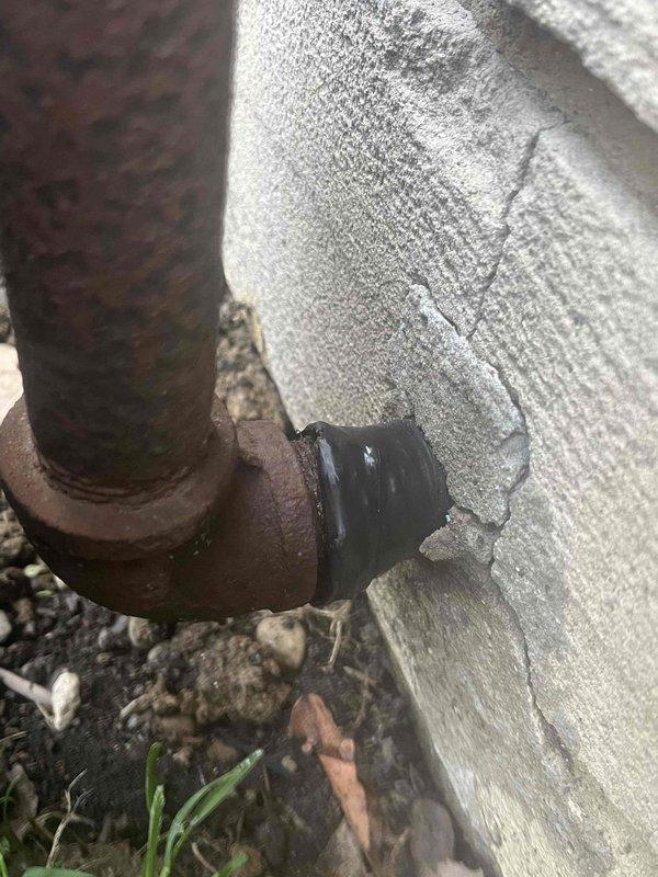 Conducted pressure test on gas line system and confirmed leak at junction where rusty iron pipe meets concrete wall. Identified significant corrosion on the main supply pipe and deterioration at connection point between newer regulator assembly and older iron pipe. Notified appropriate party of findings and recommended replacement of corroded section to restore system integrity.