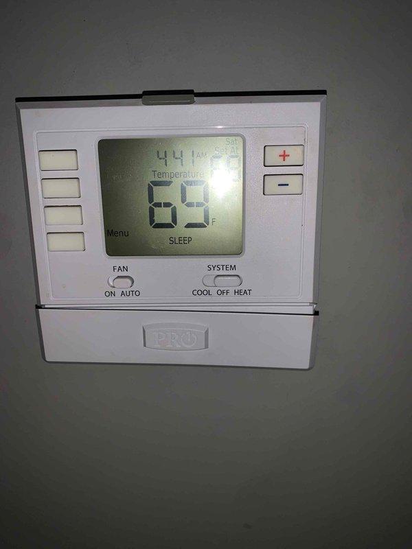 Performed scheduled heating maintenance visit. Inspected the thermostat (PRO model) which was functioning normally in SLEEP mode at 69°F. Examined blower wheel assembly and motor shaft, confirming proper condition with no visible issues or buildup requiring cleaning.