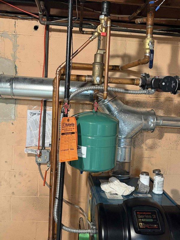 Completed follow-up service to install new expansion tank on residential boiler system. Properly fitted green expansion tank to existing copper piping network with all necessary valves and fittings. Applied scheduled coupon to final invoice as authorized by previous technician.