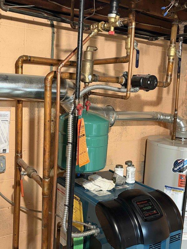 Completed follow-up service to install new expansion tank on residential boiler system. Properly fitted green expansion tank to existing copper piping network with all necessary valves and fittings. Applied scheduled coupon to final invoice as authorized by previous technician.
