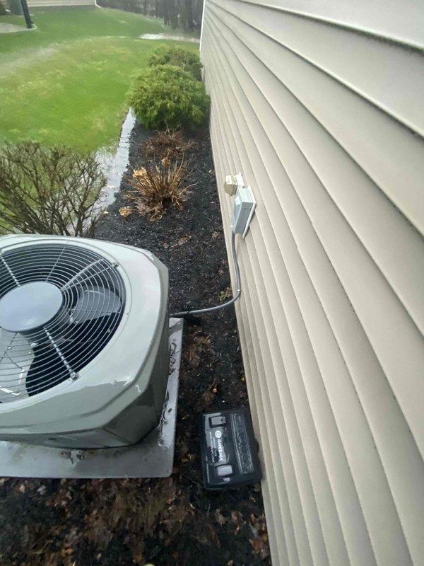 Conducted inspection of 19-20 year old gas furnace system and exterior condenser unit. Documented existing HVAC equipment condition including the outdoor AC unit positioned on concrete pad adjacent to home with beige vinyl siding, electrical disconnect box, and surrounding landscape features. Prepared replacement estimate for aging system based on comprehensive site evaluation.