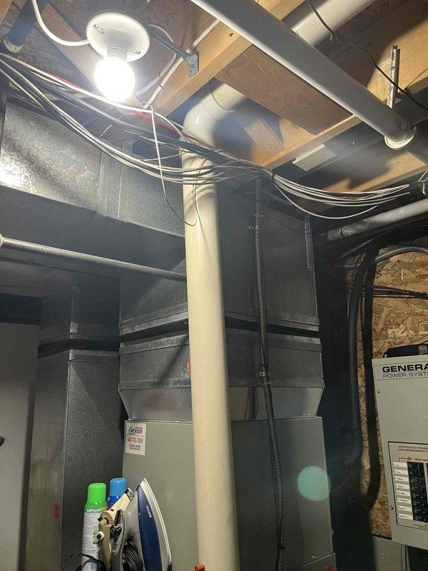 Conducted comprehensive assessment of existing HVAC system for potential replacement. Evaluated current installation featuring galvanized sheet metal ductwork, furnace/air handler unit, and associated ventilation components in utility space. Documented condition of system infrastructure including electrical connections, PVC venting, and General Power System panel for proper replacement specifications.