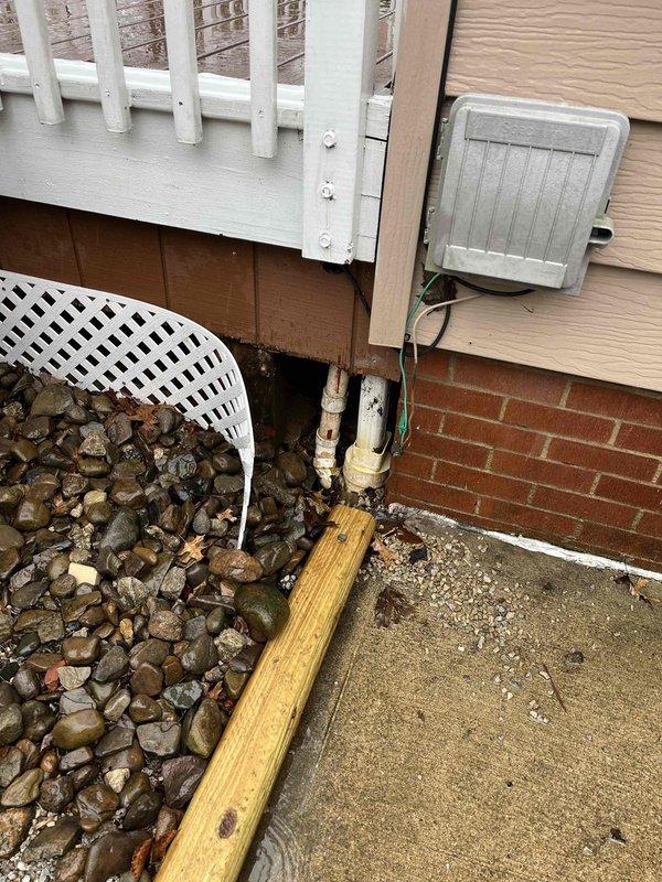 Responded to service call for non-functioning sump pump in a 60-year-old residence. Inspected the basement utility area containing the pump system, electrical panel, and associated PVC drainage pipes. Installed new control unit with monitoring display to replace faulty component. Replaced deteriorated PVC discharge pipes at exterior wall where visible weathering and joint damage were observed. System tested and confirmed operational.