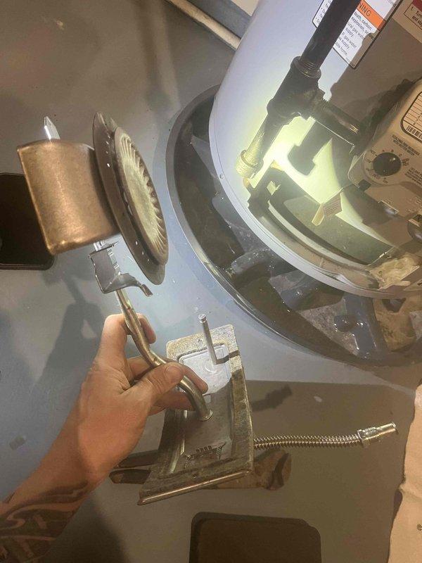 Returned to complete previously sold pilot assembly replacement on water heater. Successfully installed new pilot assembly and verified proper operation with strong blue flame visible through inspection window. Unit is now functioning correctly with stable pilot flame.