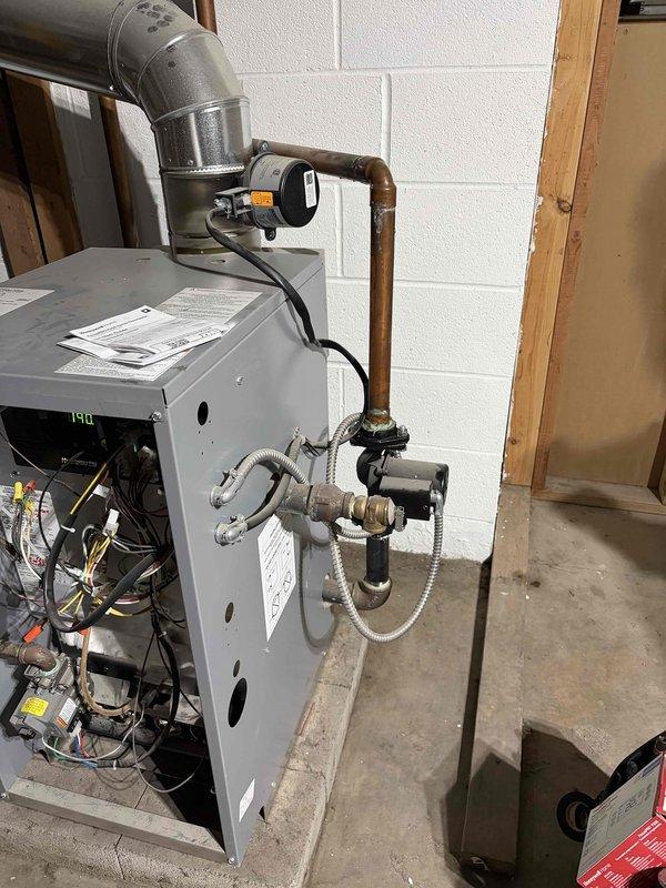 Repaired thermostat for furnace of indeterminate age by verifying proper level installation and checking electrical connections. Inspected furnace unit including vent piping, copper lines, and control mechanisms to ensure proper operation after thermostat service was completed.