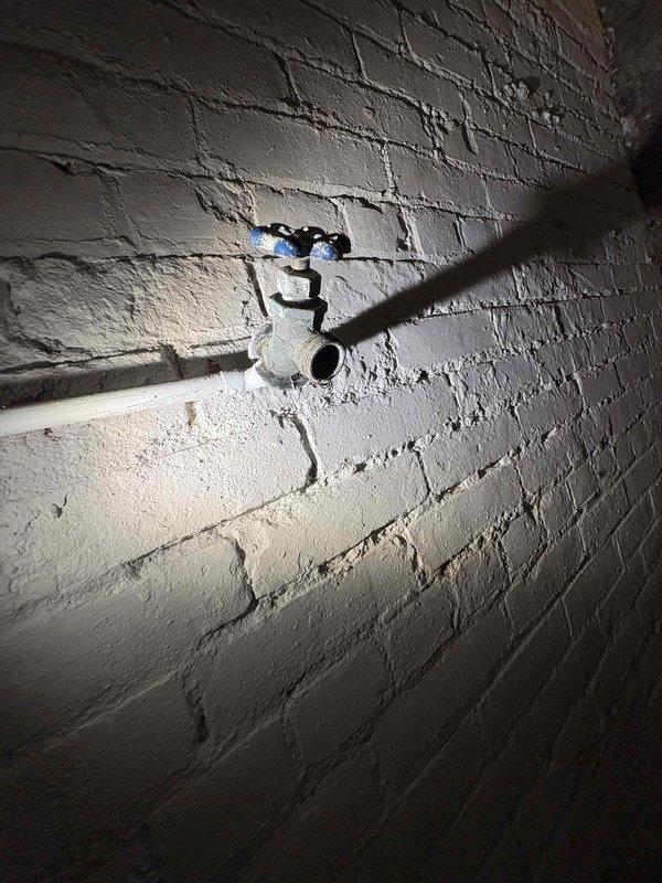Repaired burst pipe in 100-year-old home, replacing damaged section of copper piping and securing all fittings. Inspected surrounding plumbing network including multiple control valves and PVC drainage components to ensure proper function. Confirmed water flow restoration and verified absence of leaks in the repaired system.