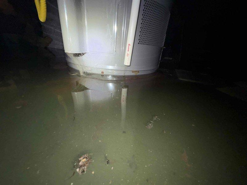 Responded to service call for basement water infiltration where customer reported backup into the house. Upon arrival, discovered significant flooding in the basement with standing water reaching several inches in depth, partially submerging appliances. Inspected the Rheem water heater system and surrounding plumbing infrastructure to identify source of leakage. Documented condition with photos for comprehensive assessment and repair planning.