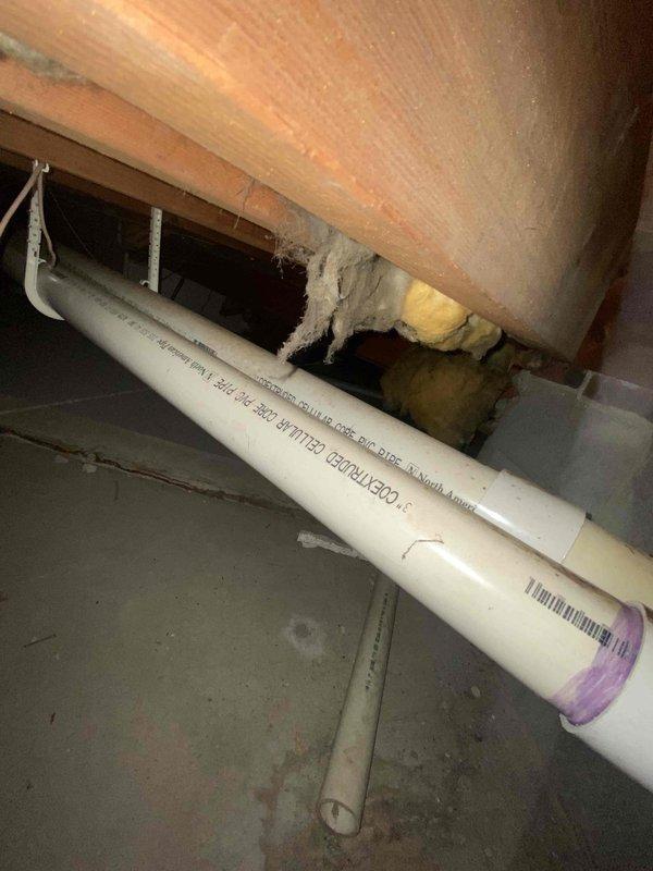 Conducted assessment of existing boiler system in basement mechanical room. Inspected blue boiler unit, associated copper piping, expansion tank, and PVC ventilation components. Documented current installation configuration and noted presence of PVC drainage pipe in crawl space with proper clearances to structural elements.