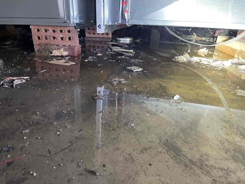 Responded to service call for Lennox furnace (2022) located in crawlspace making clicking sounds during startup. Upon inspection, discovered severe flooding in the crawlspace with standing water submerging portions of the HVAC system. Service could not be safely completed due to hazardous water conditions; recommended emergency water extraction and system evaluation after area is dried to prevent electrical hazards and equipment damage.