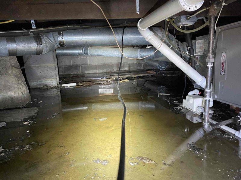 Responded to service call for Lennox furnace (2022) located in crawlspace making clicking sounds during startup. Upon inspection, discovered severe flooding in the crawlspace with standing water submerging portions of the HVAC system. Service could not be safely completed due to hazardous water conditions; recommended emergency water extraction and system evaluation after area is dried to prevent electrical hazards and equipment damage.