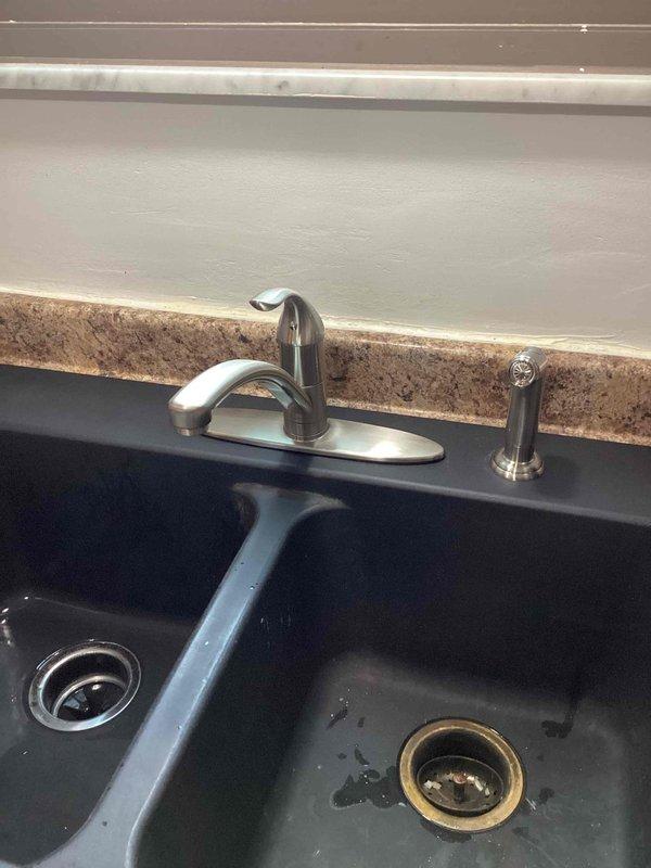 Successfully completed installation of a kitchen faucet replacement (option 2) as sold previously. Installed new chrome single-handle faucet with separate sprayer/soap dispenser on the double-basin composite sink, connecting all required supply lines and ensuring proper function of the new fixture.