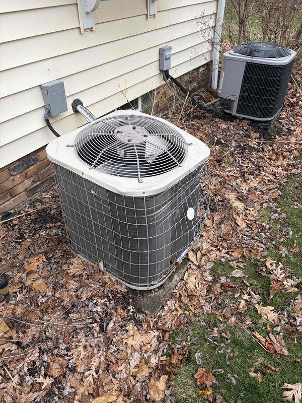 Conducted visual inspection of 5-year-old AC condenser unit showing exterior weathering and age-related wear. System was found to be operating properly despite minor cosmetic damage to the condenser housing. No service quote was provided as this was booked as an estimate only.