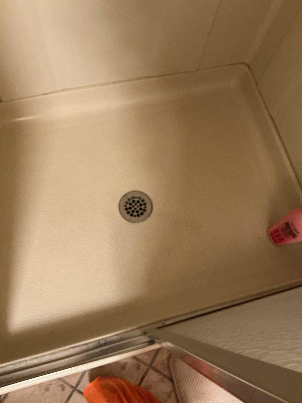 Conducted routine plumbing maintenance visit to investigate reported issues with hot water odor and mineral buildup. Inspected shower drain and faucet systems, documenting current condition with photos. Tested water flow from kitchen/bathroom faucet and examined shower drain for potential causes of the reported problems.