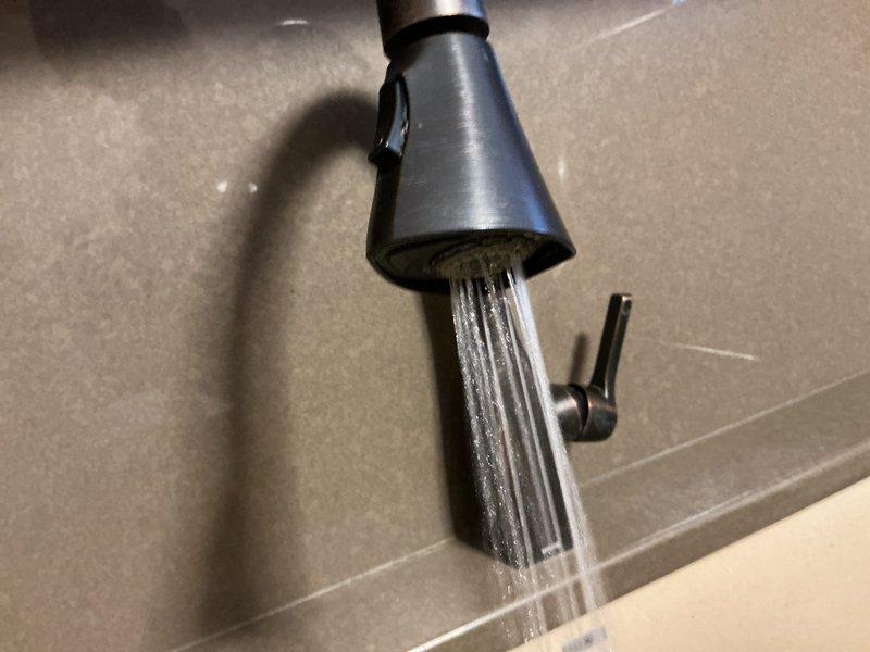 Conducted routine plumbing maintenance visit to investigate reported issues with hot water odor and mineral buildup. Inspected shower drain and faucet systems, documenting current condition with photos. Tested water flow from kitchen/bathroom faucet and examined shower drain for potential causes of the reported problems.